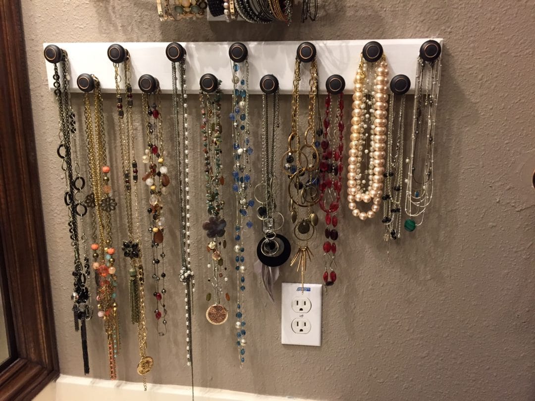 Items needed for DIY jewelry stand include 2-3 plates (Goodwill, 25 to 50  cents each); 1-2 vases (Goodwill, 50 cents each); something to fill a clear  vase, if using; and hooks (Wal-Mart